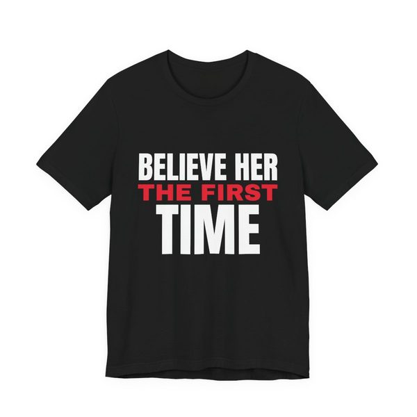 Black t-shirt reading Believe Her the First Time